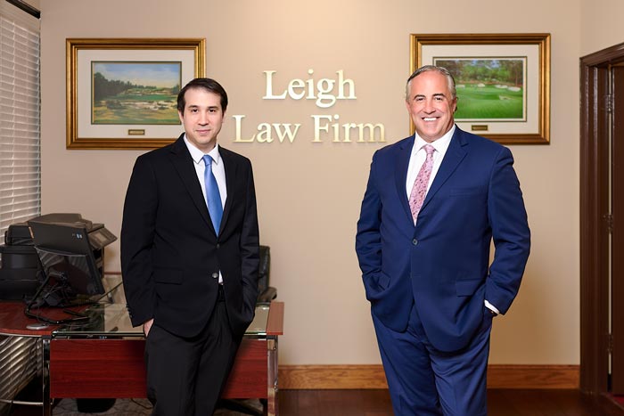 Attorneys Matthew J. Henry and Bradford G. Leigh standing in office lobby